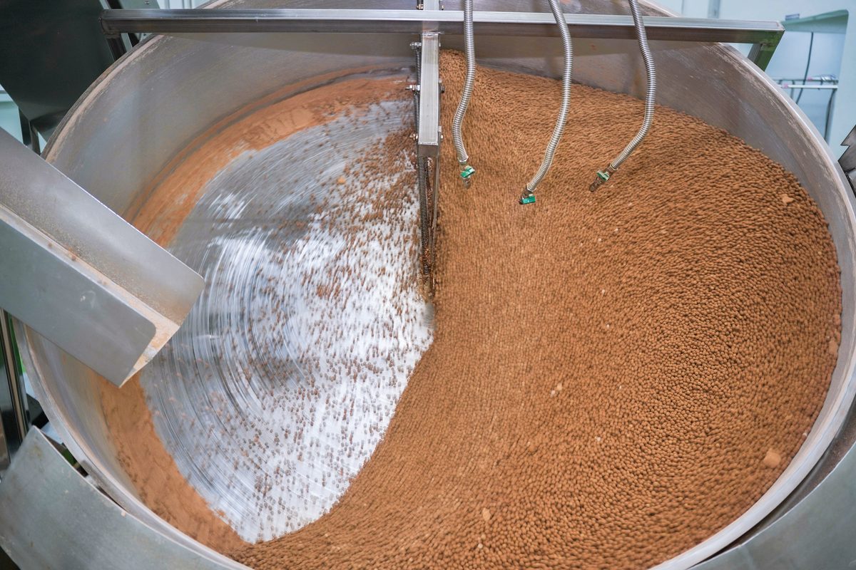 Tapioca starch and brown sugar being rolled in a large rotating pan.